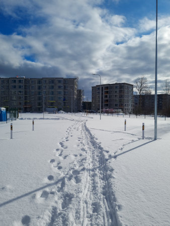Modern apartment complex in a construction process. Multi-storey apartment area with a private leisure area. Residential complex construction site during the winter.の写真素材