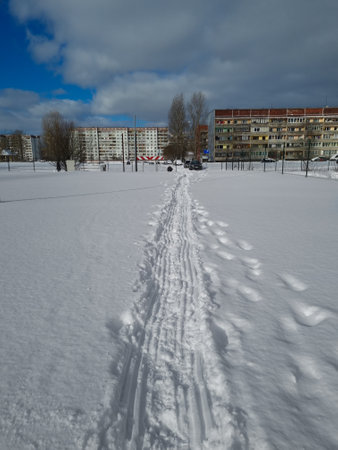 Multi-storey residential houses stand in line. Living apartment complex. Side view on a suburban district with average living houses. Winter landscape in the suburbs.の写真素材