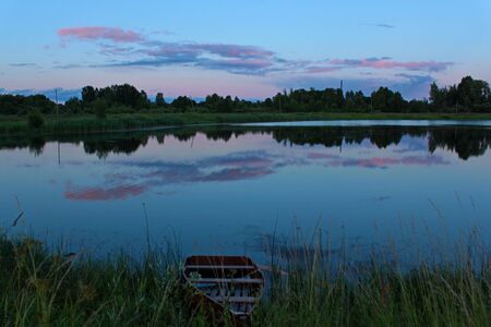 Photo of a summer sunset by the pondの写真素材