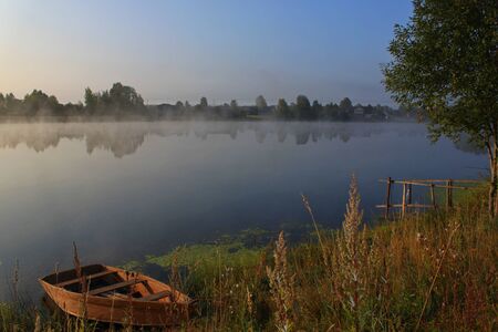 Photo of morning fog over the water of a pondの写真素材