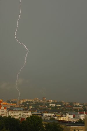 Photo of lightning in the sky above the cityの写真素材
