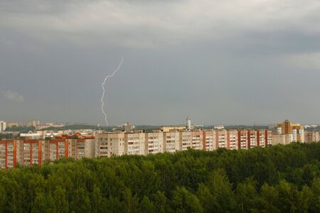 Horizontal photo of lightning in the sky above the city.の写真素材