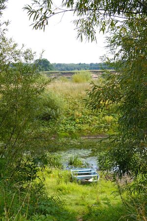 Photo of the river Bank with a boatの写真素材