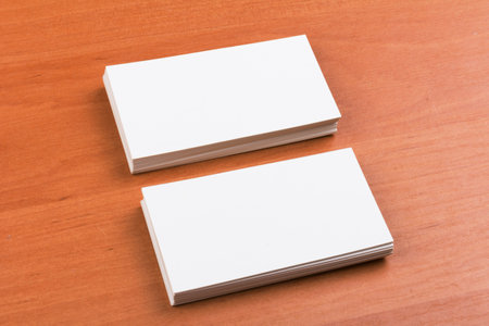 stacks of white blank business cards on a wooden surfaceの写真素材