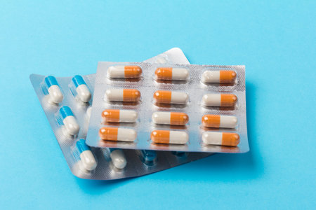 Ð¡apsules on blue background. Copy space. Global healthcare concept. Pharmaceutical industry.