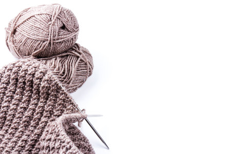 knitting needles and dark gray woolen threads on white background. natural wool knitting backgroundの写真素材