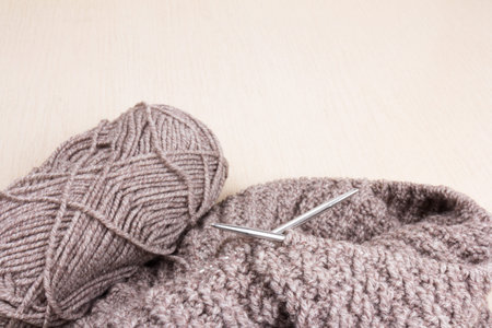 dark gray woolen threads on wooden background. natural wool knitting background