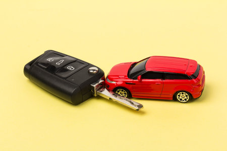 Red car and key. Concept of car loan, purchase of a new car.