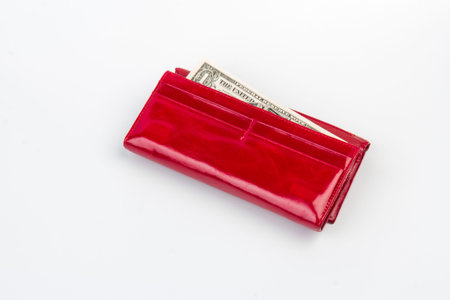 A red female wallet with last US dollar bil. The concept of poverty and bankruptcy