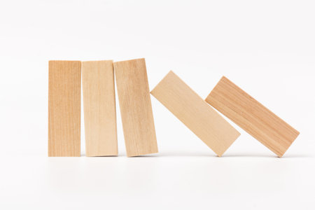Wooden block standing and outstanding among the collapse of fall in line, business concept able to...