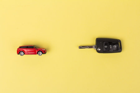 Red car and key. Concept of the automobile loan, saving money for car, trade car for cash, the concept of Finance.の写真素材