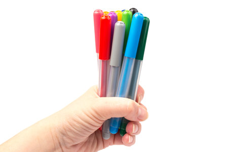 Colorful marker pens in hand isolated on white background. Kids vivid painting tools, various color...