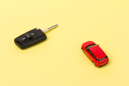 Red car and key. Concept of car loan, purchase of a new car.