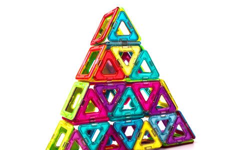 Magnetic designer for development of motor skills, thinking and imagination. Construction assembled from multi-colored parts of children's magnetic designerの写真素材