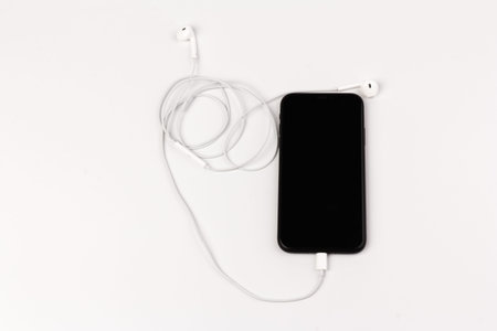 Headphone and phone on white background. Ready to listen to musicの写真素材