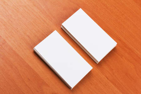stacks of white blank business cards on a wooden surfaceの写真素材