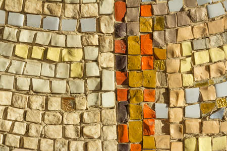 Detail of beautiful old collapsing abstract ceramic mosaic adorned building. Mosaic as decorative background. Selective focus. Abstract Pattern. Abstract mosaic colored ceramic stonesの写真素材