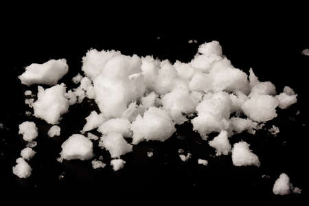 pile of white snow isolated on black background. The structure of snow and ice. Close-up.の写真素材