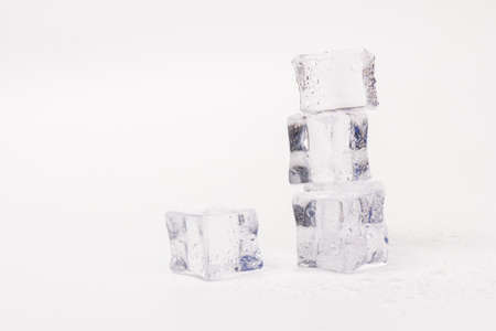 Pyramid of transparent ice cubes. Ice cubes close up on gray background. space for textの写真素材
