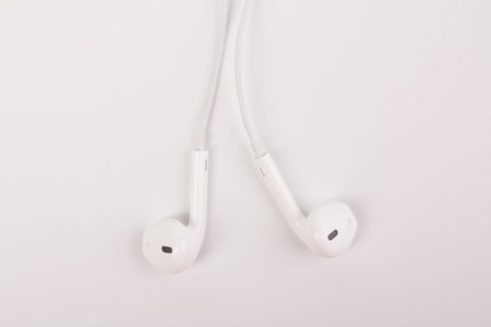 White headphones for listening to music and sound on portable devices: music player, smartphone,...