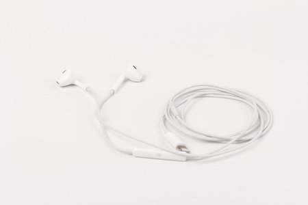 White headphones for listening to music and sound on portable devices: music player, smartphone,...