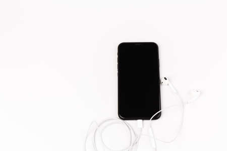 Headphone and phone on white background. Ready to listen to music.の写真素材