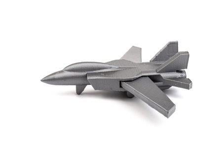 Model gray miniature fighter jet created on a 3d printer, on white background. transportation...