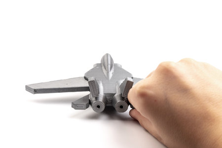 Model gray miniature fighter jet created on a 3d printer, on white background. transportation...