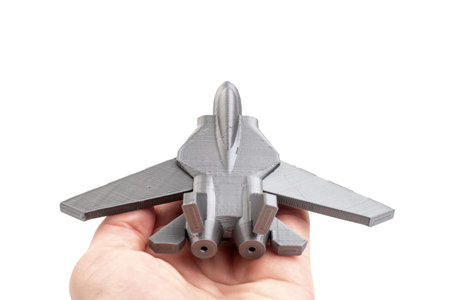 Model gray miniature fighter jet created on a 3d printer, on white background. transportation...