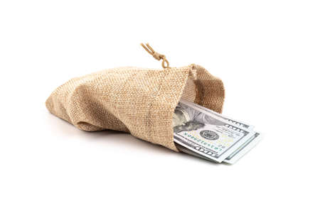 dollars in a burlap sack isolated on white backgroundの写真素材