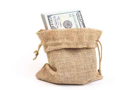 dollars in a burlap sack isolated on white backgroundの写真素材