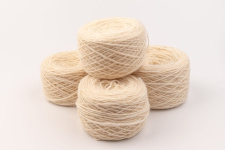 Ball of white wool yarn on white background. Knitting thread
