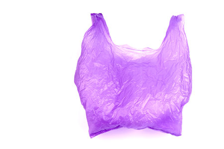 Transparent purple plastic bag with handles isolated over white backgroundの写真素材