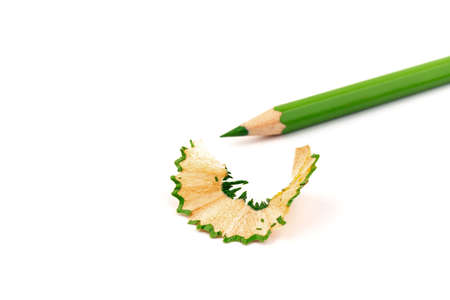 Color wood pencil with sharpening shavings isolated on a white background. Wooden pencils with shaving garbage, waste or cutting peelの写真素材