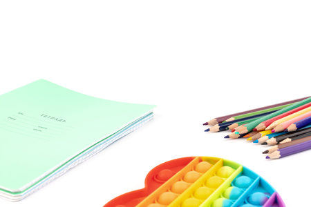 Notebooks, toy popit and crayons - concept with space for text on the subject of schoolの写真素材