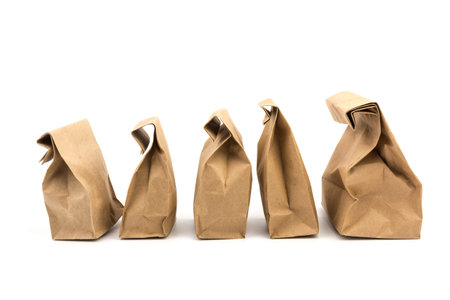 full paper disposable bag of brown kraft paper isolated on white background, concept of rejection of...