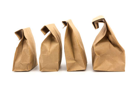 full paper disposable bag of brown kraft paper isolated on white background, concept of rejection of plastic packaging, template for designer, packaging for contactless product deliveryの写真素材