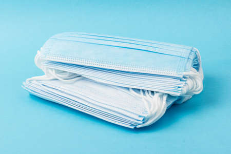 Prevent coronavirus. Medical mask, Medical protective mask isolated on blue background. Disposable surgical face mask cover mouth and nose. Healthcare medical Coronavirus quarantine, hygiene conceptの写真素材