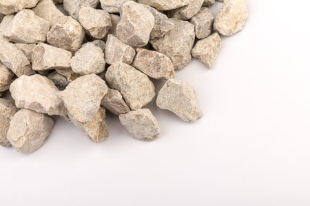 Gray small rocks ground texture isolated on white background. Small road stone. Gravel pebbles stone. crushed granite gravel, close up.の写真素材