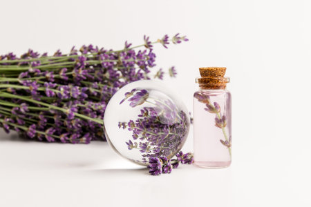 lavender essential oil in a beautiful bottle on the light backgroundの写真素材