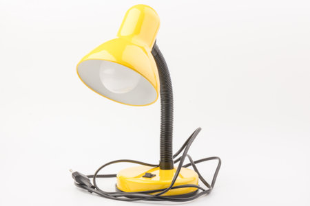 Yellow desk lamp isolated on white background. The concept of day and nightの写真素材