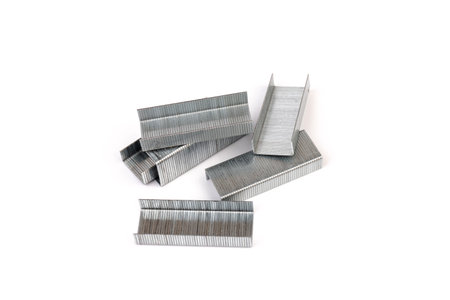 Close up stack of metal staples for stapler on a white background