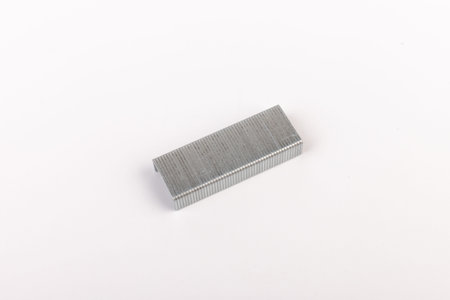 Close up stack of metal staples for stapler on a white background