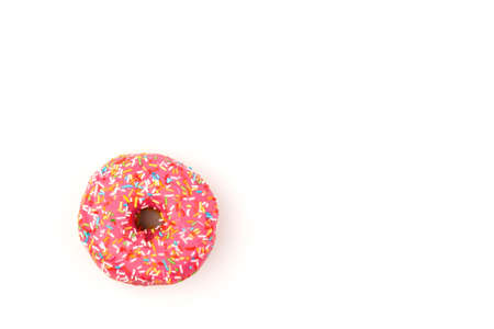 Donuts with strawberry icing and multicolored sprinkles, isolated on a white background. Traditional sweet pastries. Place for text.の写真素材