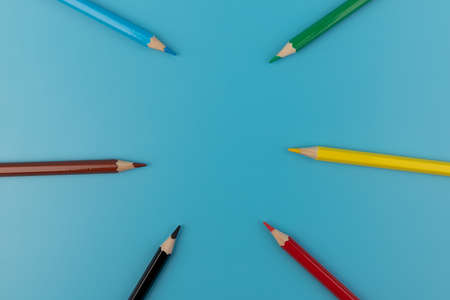 Composition with colored pencils on a bright blue background. top view. space for text.frameの写真素材