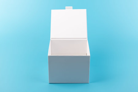 Opened white paper box on a blue background. Place for you design.