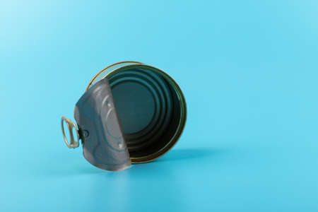 Opened pull cap of empty food can, isolated on blue backgroundの写真素材