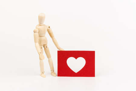 A wooden mannequin imitate the action of people.Valentines day concept. Copy space.の写真素材