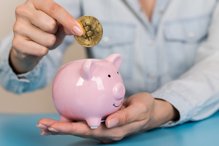 Piggy bank with bitcoin coin on blue background, space for text. Finance, saving moneyの写真素材