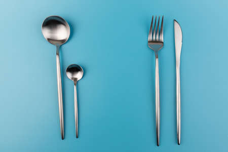 fork, knife, spoon, cutlery on blue background.の写真素材
